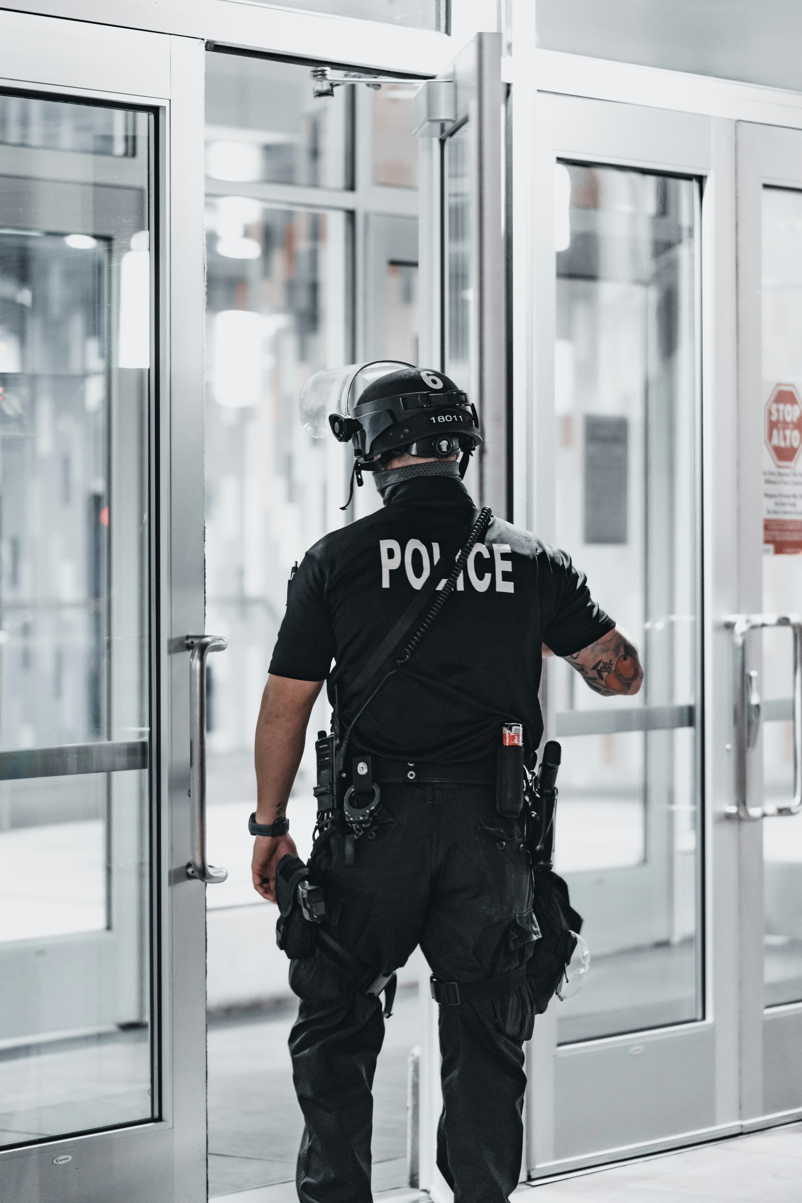 Police officer standing at a building entrance